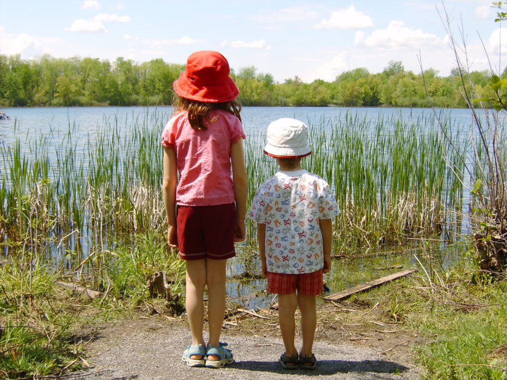 Two children by a lake