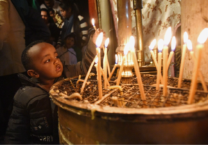 Ethiopian boy lighting an advent candle