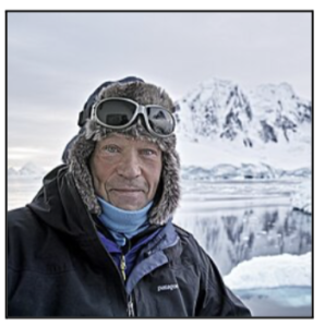 Closeup of explorer Robert Swan in front of Antarctic mountains