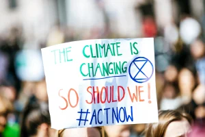 Sign with "The climate is changing, so should we! #ActNow"
